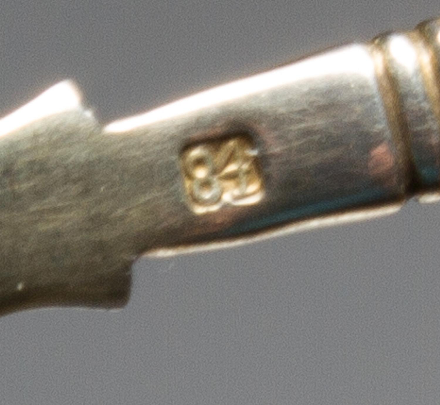 A Russian Enameled Silver and Plique-a-Jour Tea Scoop, , having a polychrome enamel and twist decorated handle, the scoop surrounded wi