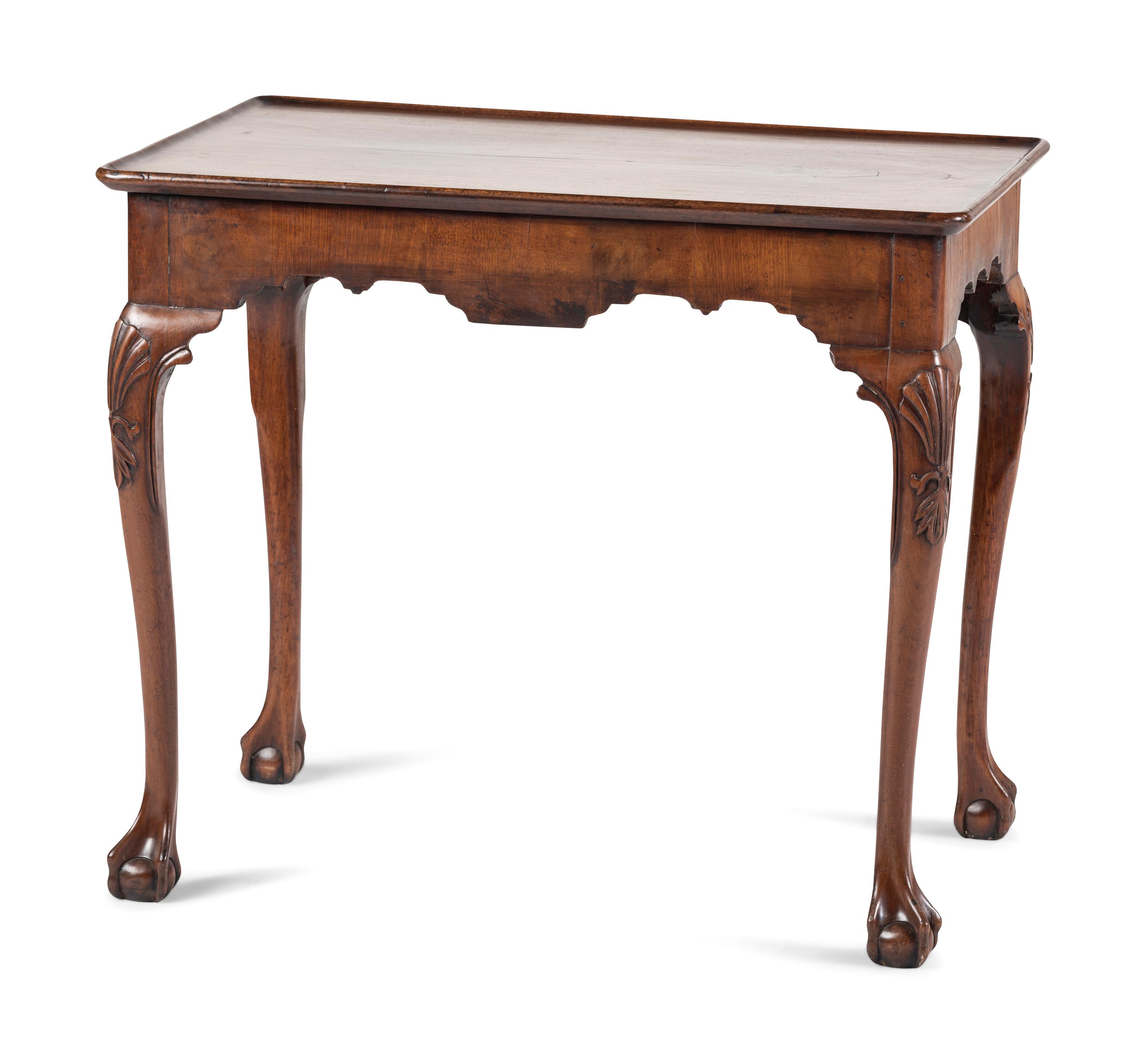 A Queen Anne Shell-Carved and Veneered Walnut Dish-Top Claw-and-Ball Foot Tea Table