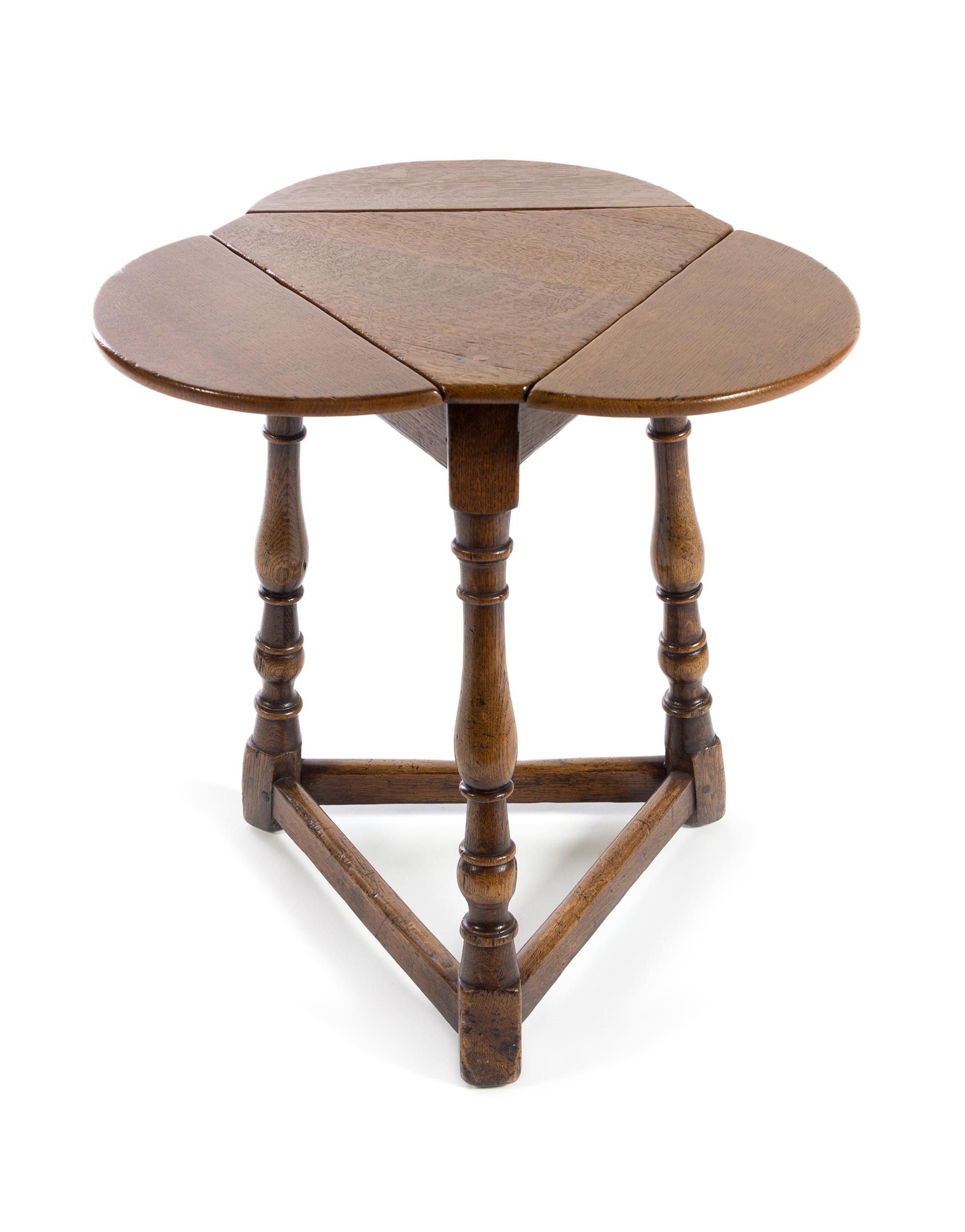 A Jacobean Style Oak Drop-Leaf Table Height 22 inches. — 20TH CENTURY
