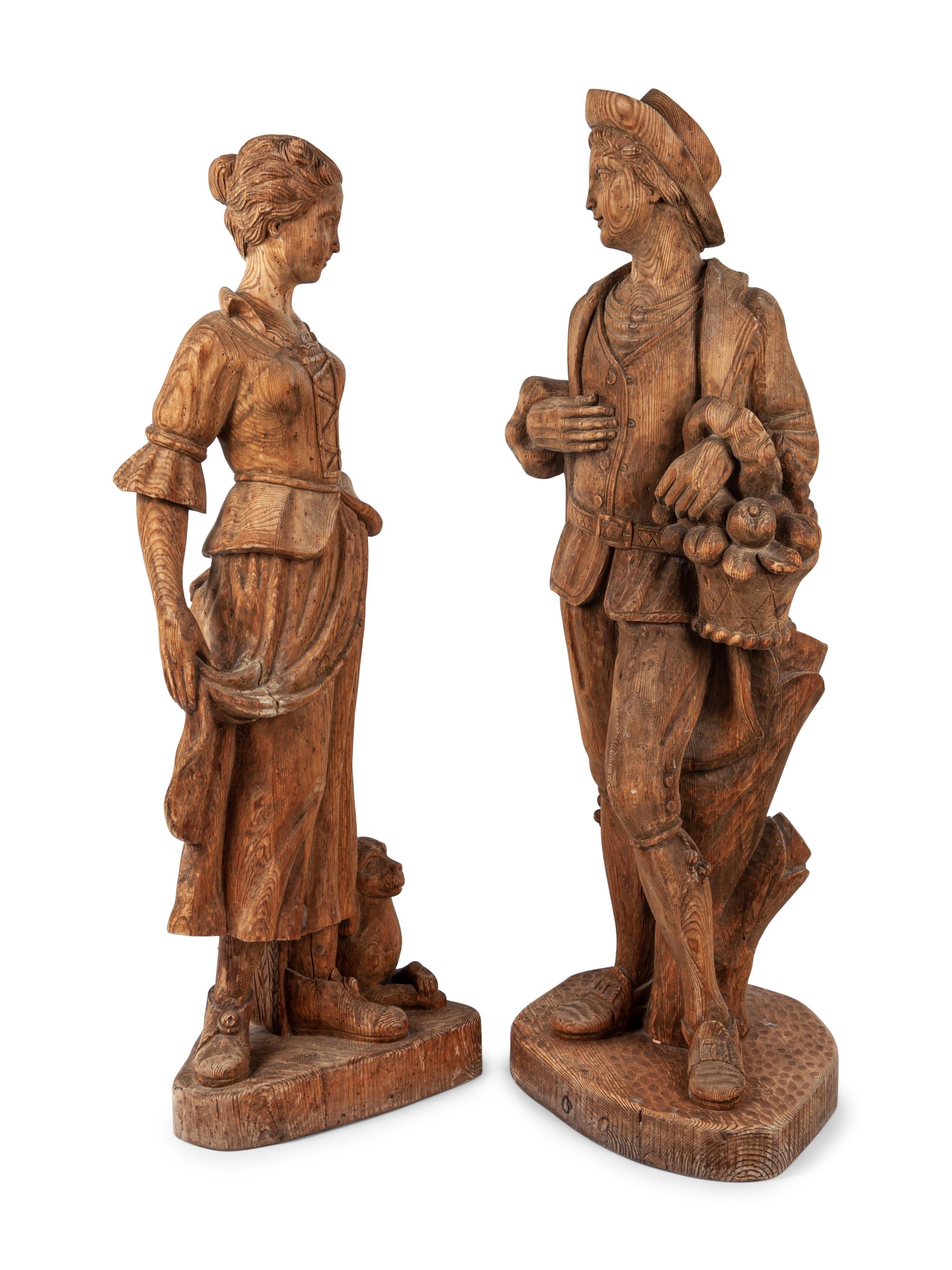 A Pair of Continental Carved Pine Figures