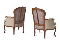 A Pair of Louis XV Carved Walnut Bergères