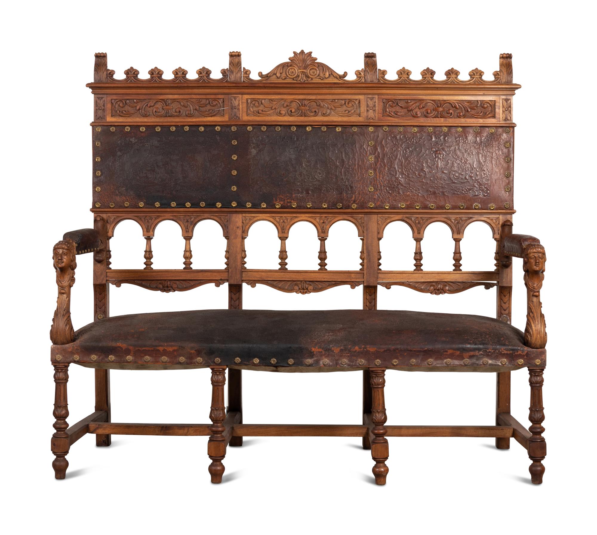 An Austrian Carved Walnut Bench with Tooled Leather Upholstery