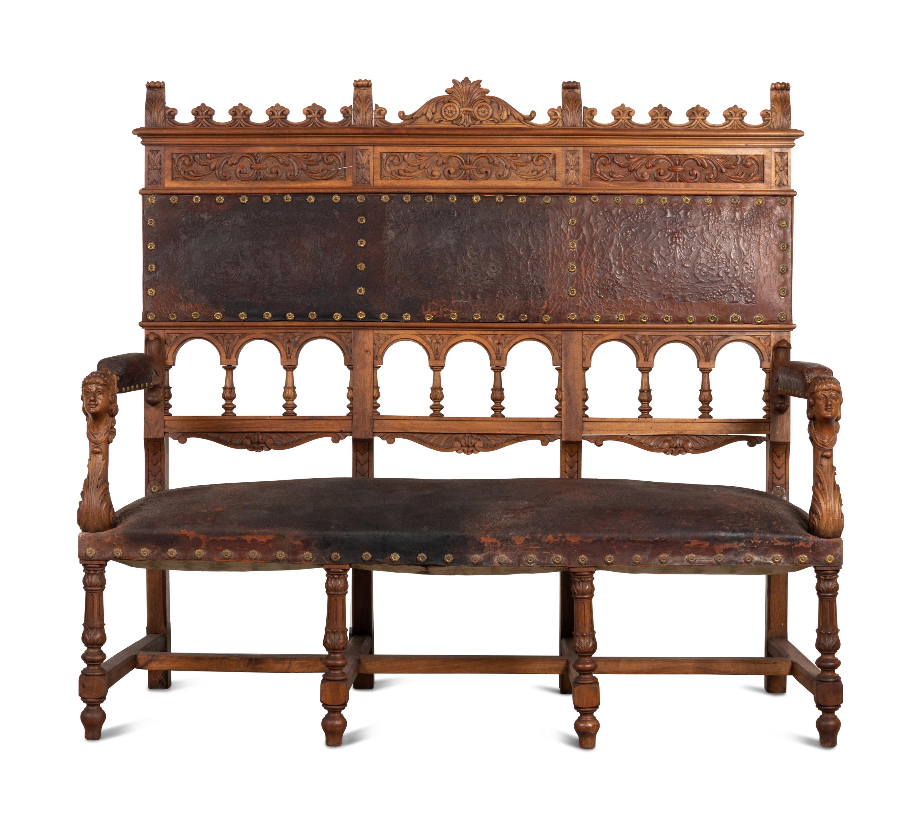 An Austrian Carved Walnut Bench with Tooled Leather Upholstery
