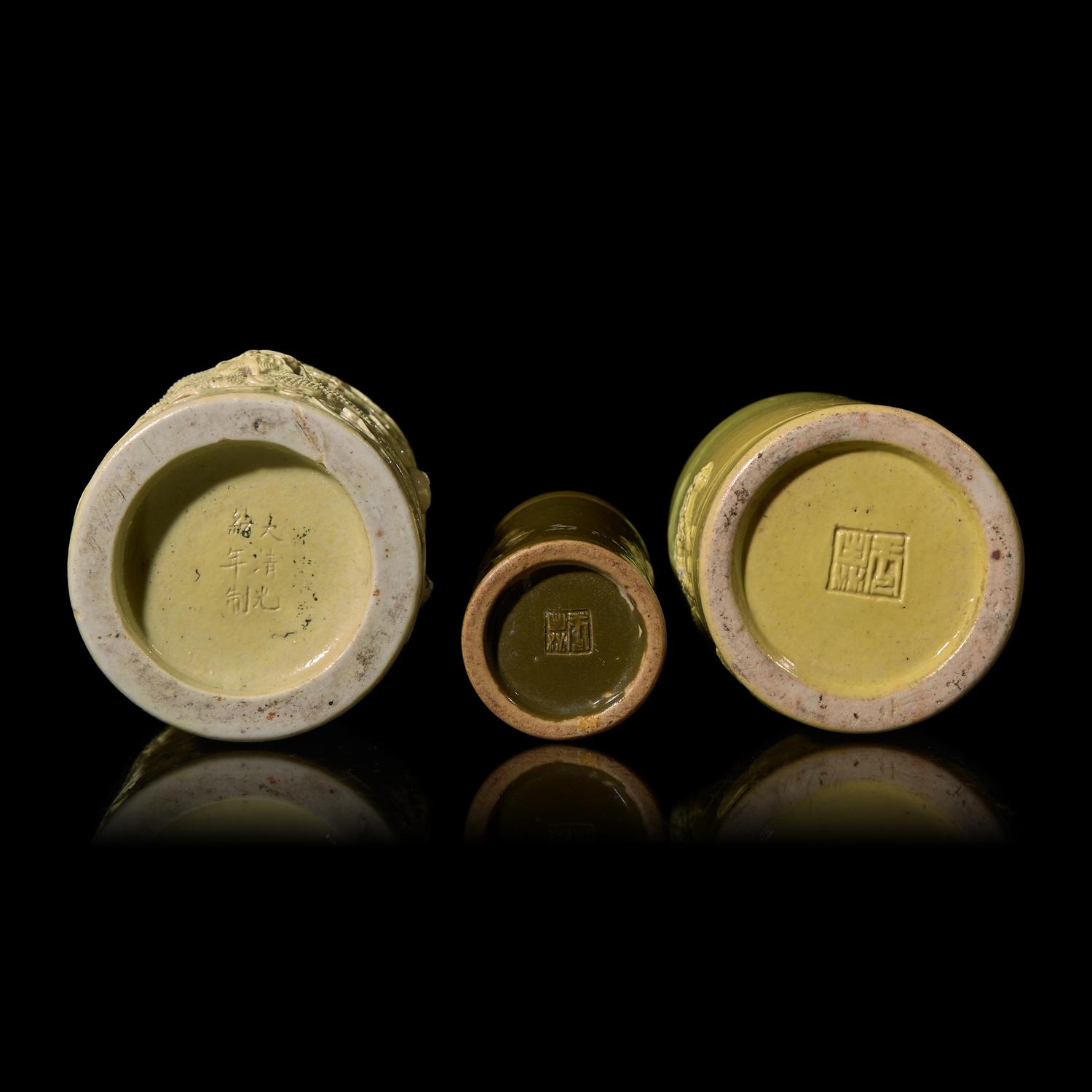 A Chinese Teadust Glazed Porcelain Joss-Stick Holder and Two Yellow Glazed Porcelain Brushpots, Bitong, Late Qing Dynasty-Republic Period 晚清-民國 模印雕瓷三件