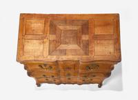 A Louis XV Provincial Carved Fruitwood Serpentine and Paneled-Top Bombé Commode