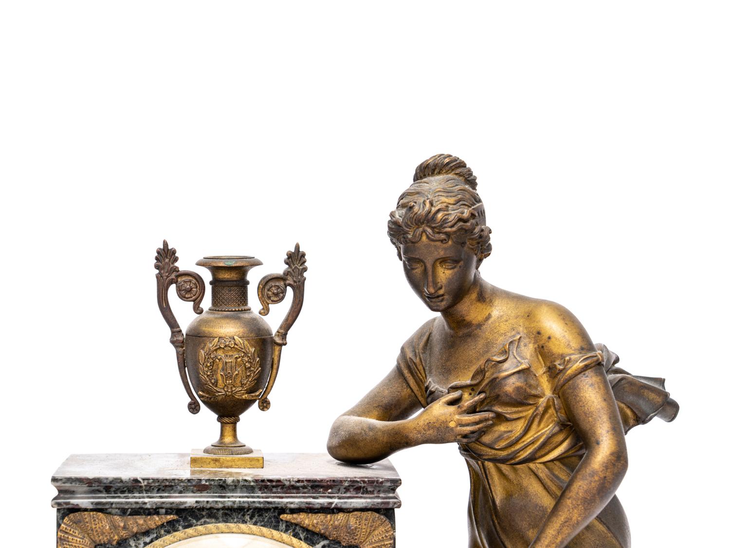 An Empire Style Gilt Metal and Marble Figural Mantel Clock