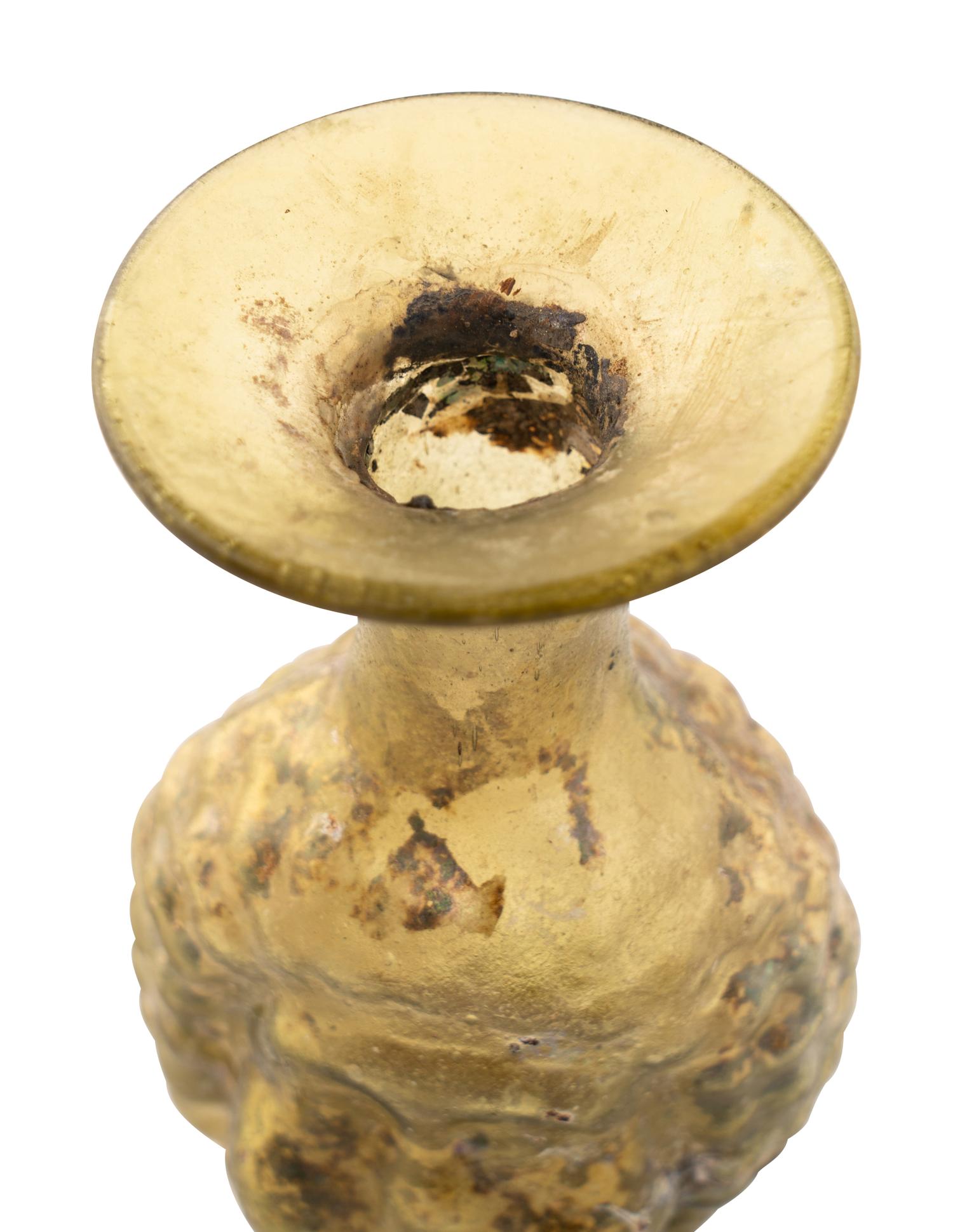 A Roman Glass Janus Head Flask