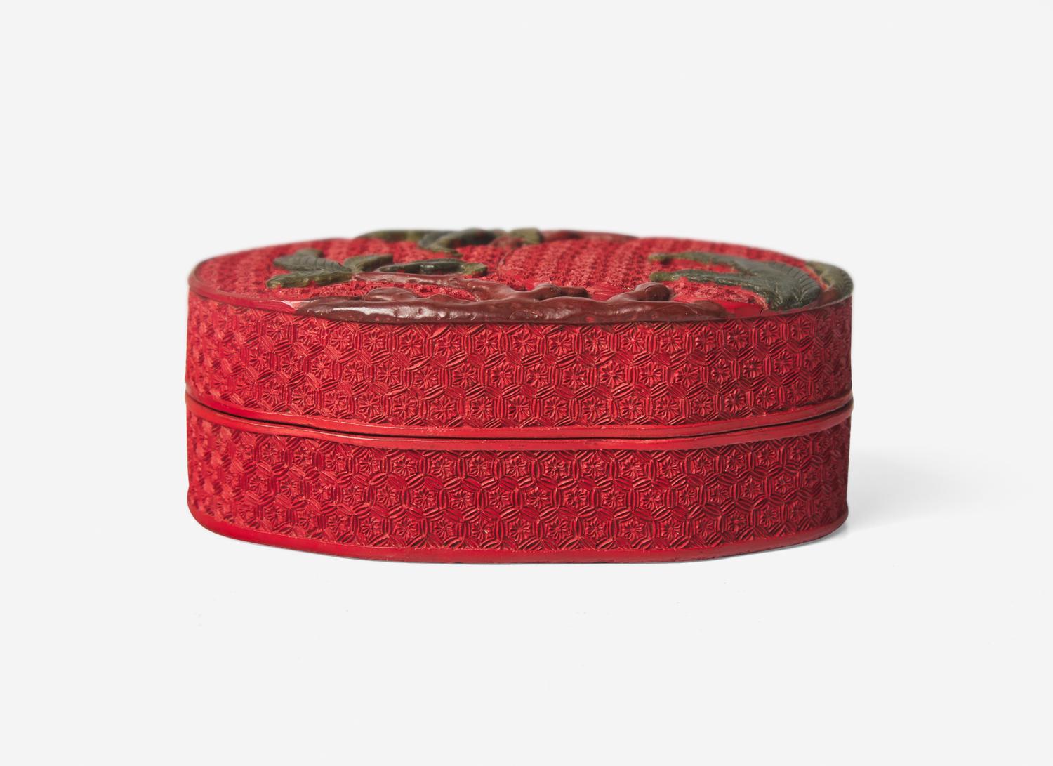A Chinese Polychromed Cinnabar Lacquer 'Peaches' Covered Box