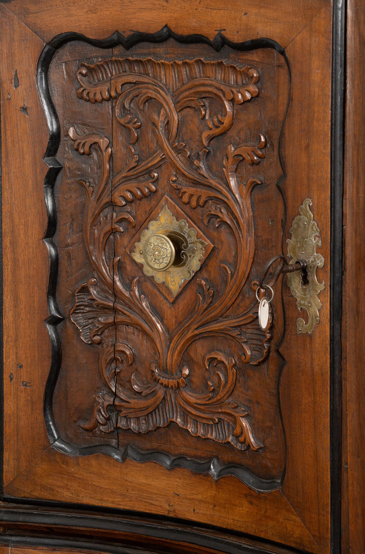 A Portuguese Carved Walnut Parcel Ebonized Bureau Cabinet on Chest
