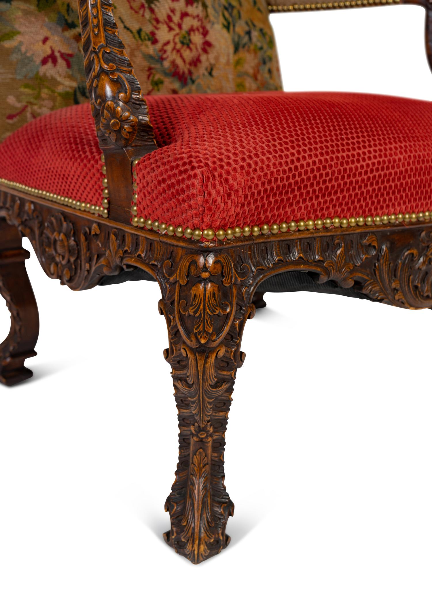 A Régence Style Carved Walnut Bergère à Oreilles with Petit Point Upholstery