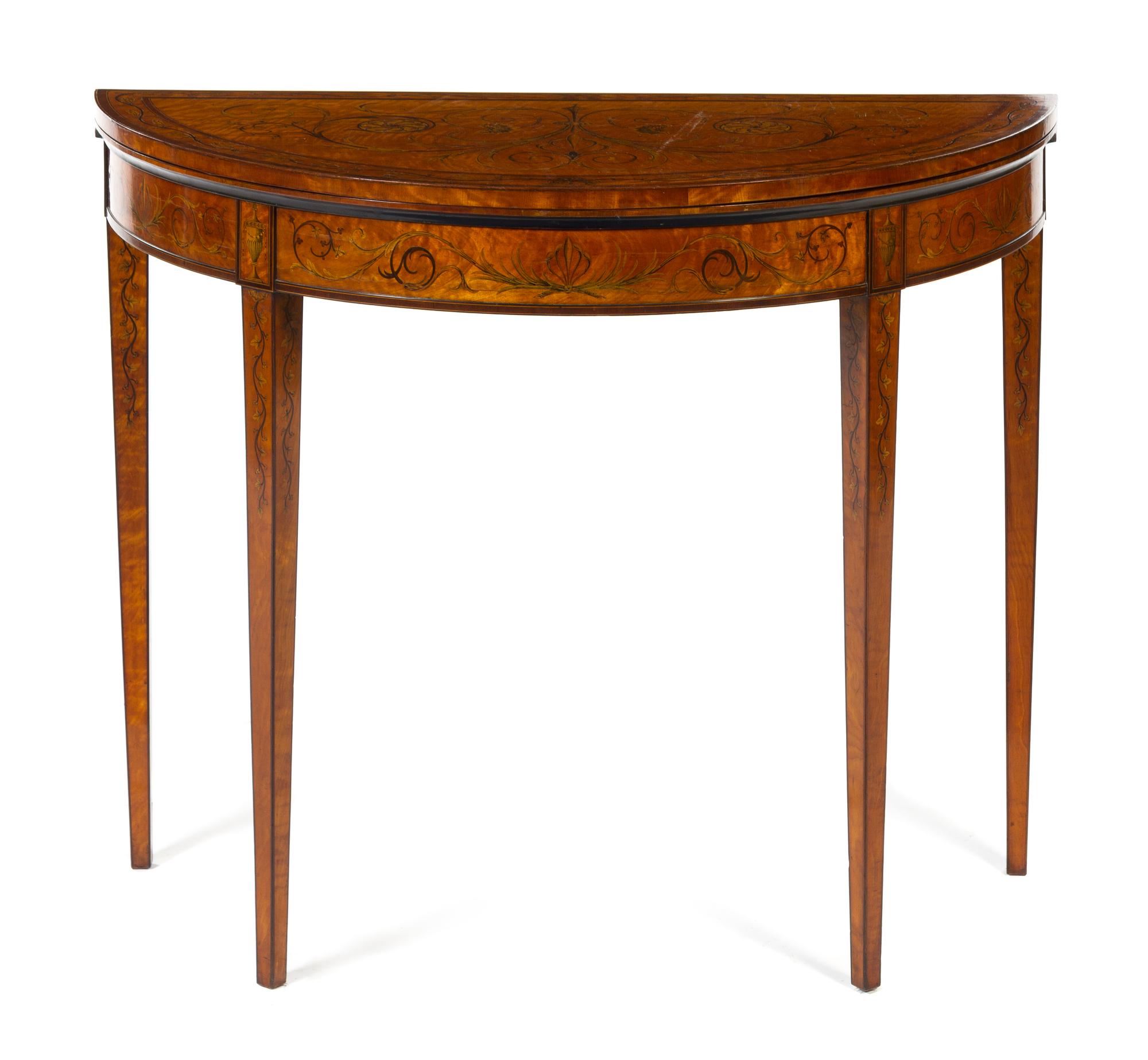 A Sheraton Style Satinwood and Marquetry Flip-Top Game Table Height 30 x width 37 x depth 17 inches (closed). — MID-19TH CENTURY