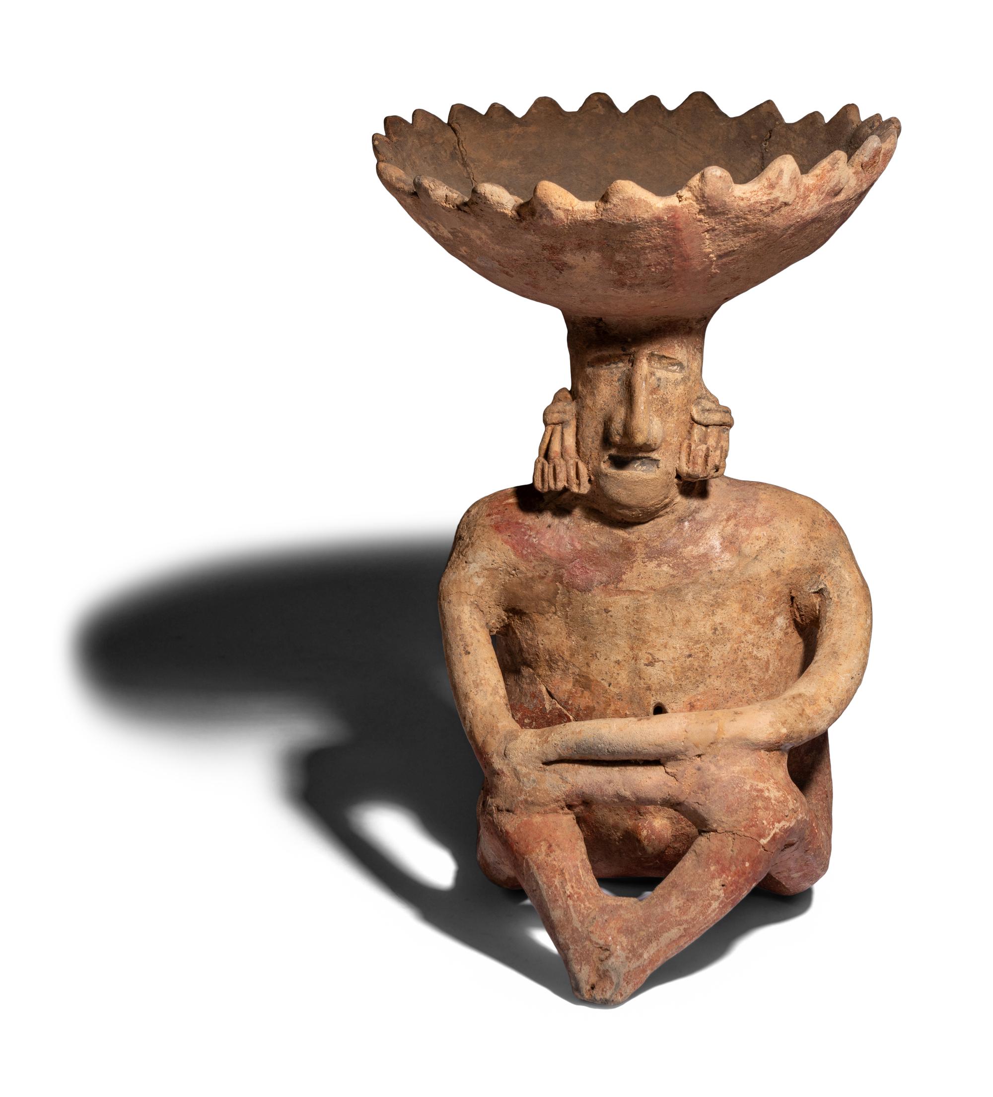A Colima Terracotta Seated Figure with Bowl Head