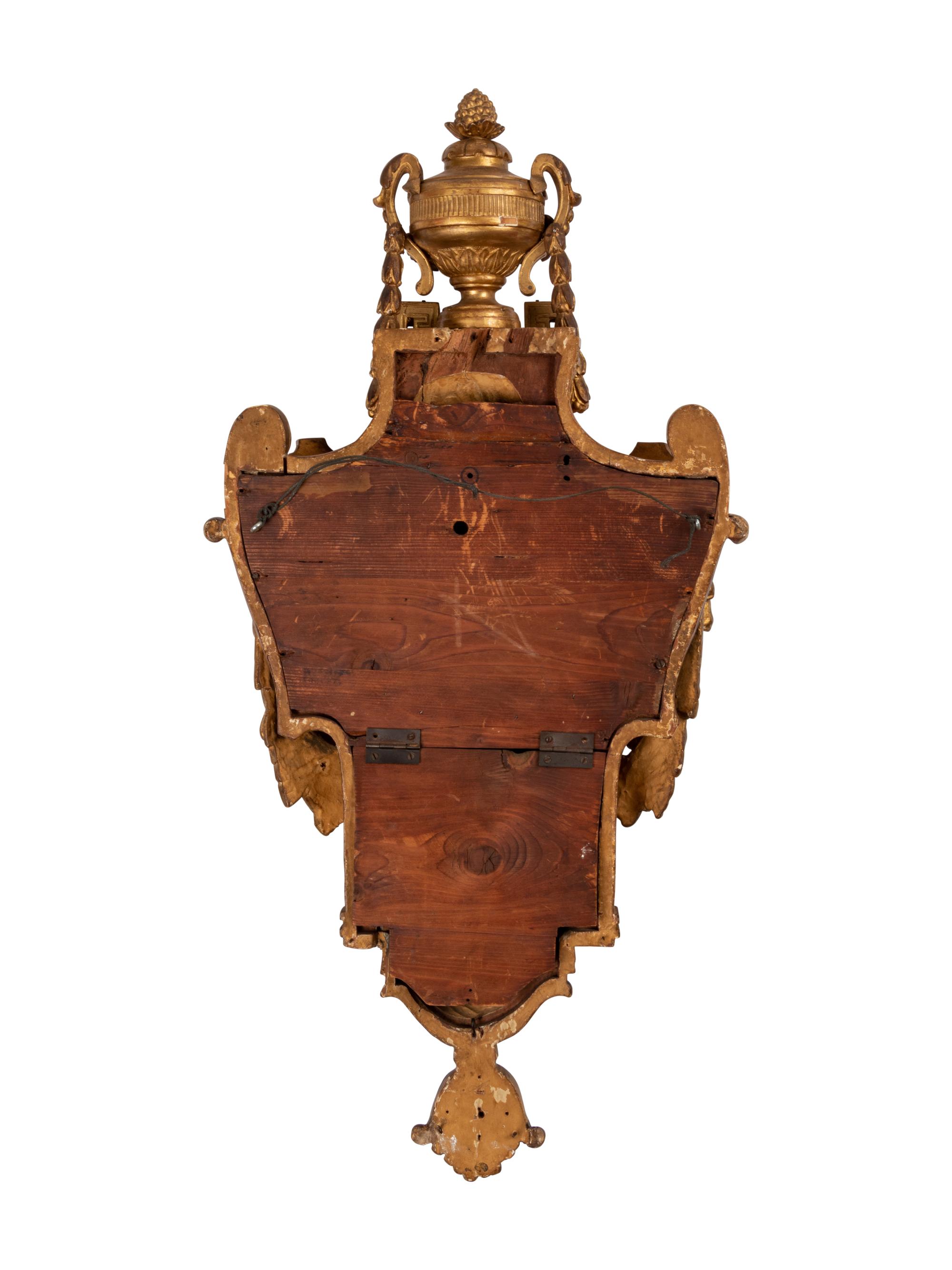 A Louis XVI Style Giltwood Cartel Clock