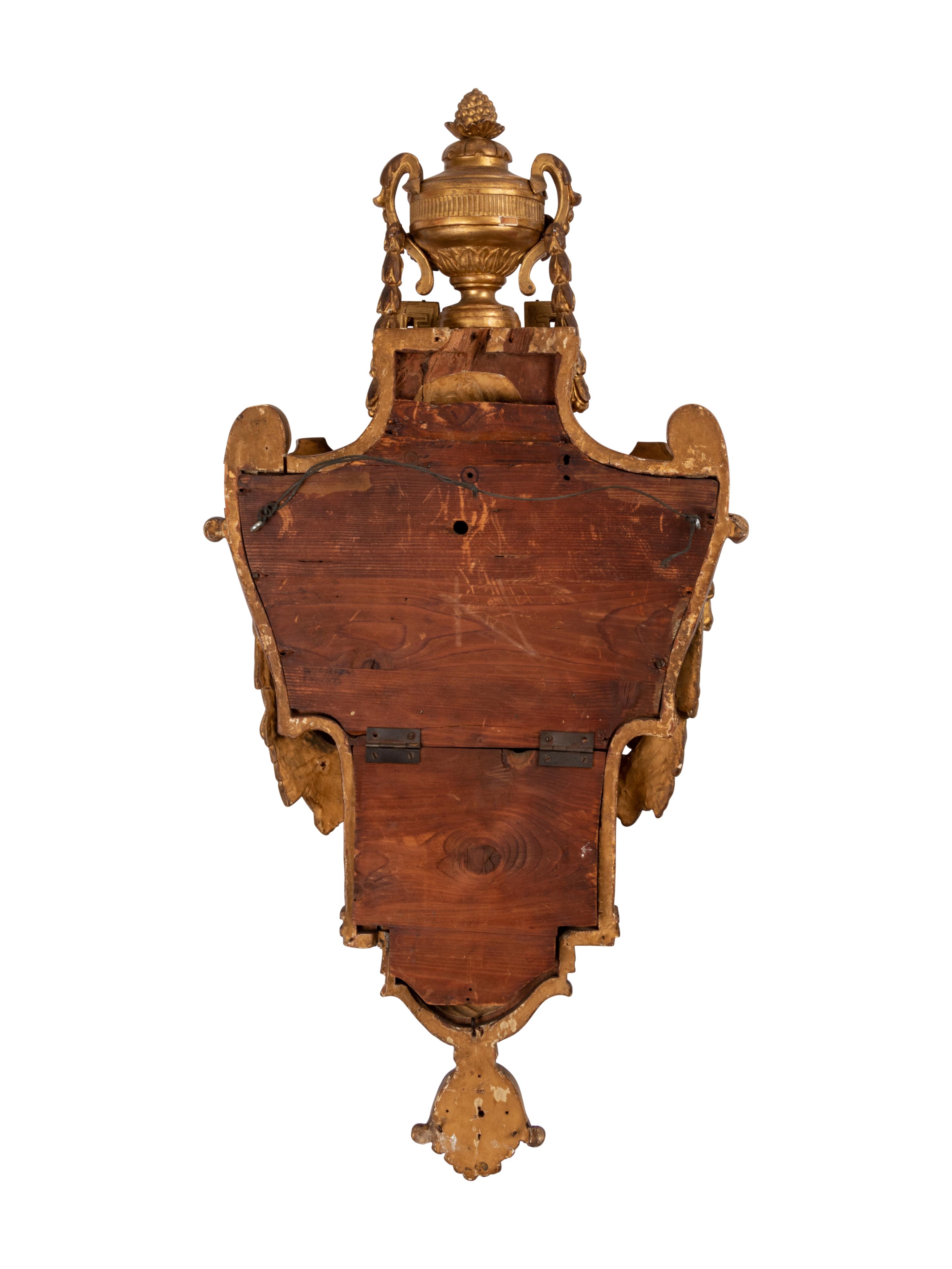 A Louis XVI Style Giltwood Cartel Clock