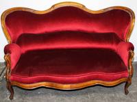 A Victorian Style Walnut Camelback Settee Height 42 x width 68 x depth 36 inches. — FIRST QUARTER 20TH CENTURY