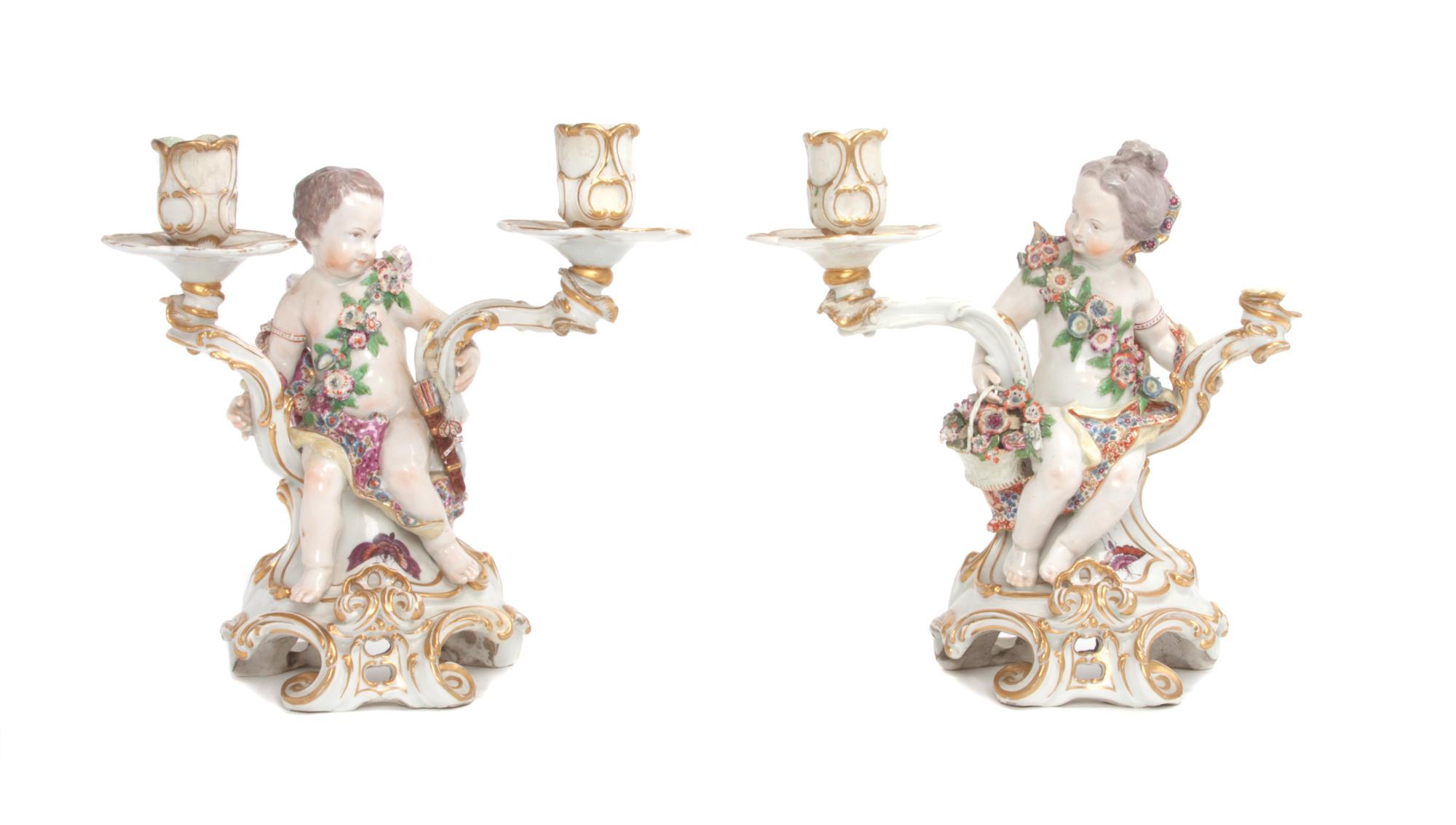 A Pair of Chelsea Porcelain Figural Two-Light Candlesticks Height 11 inches.