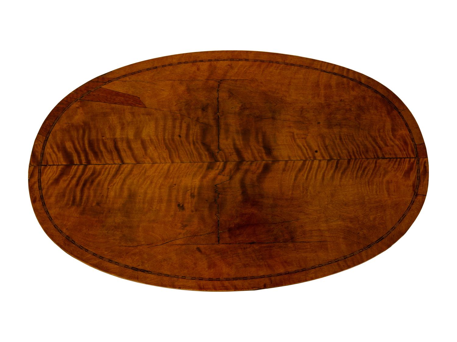 A Regency Inlaid Satinwood, Ebonized and Parcel Gilt Oval Work Table — EARLY 19TH CENTURY