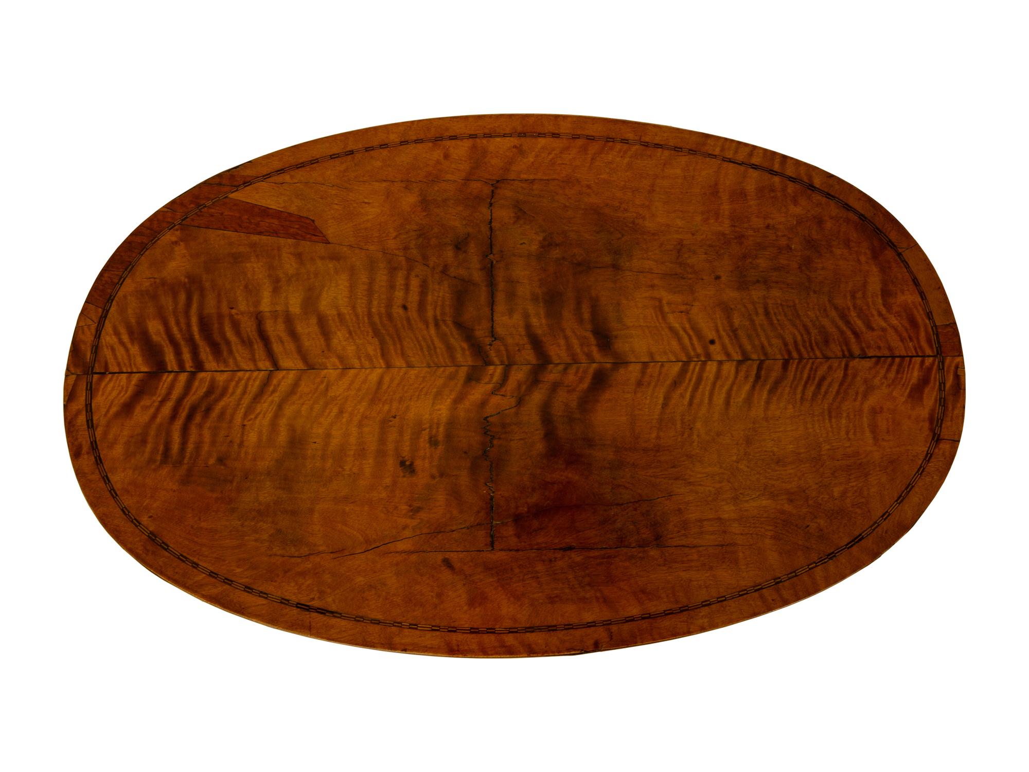 A Regency Inlaid Satinwood, Ebonized and Parcel Gilt Oval Work Table — EARLY 19TH CENTURY