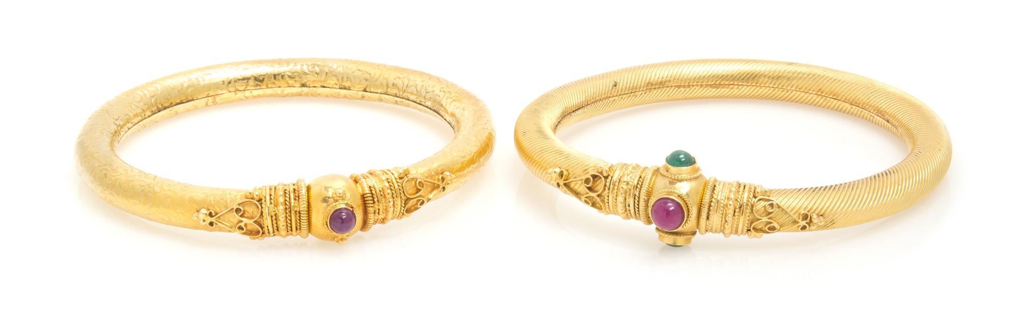A Collection of High Karat Gold, Ruby and Emerald Bangle Bracelets, 33.60 dwts.