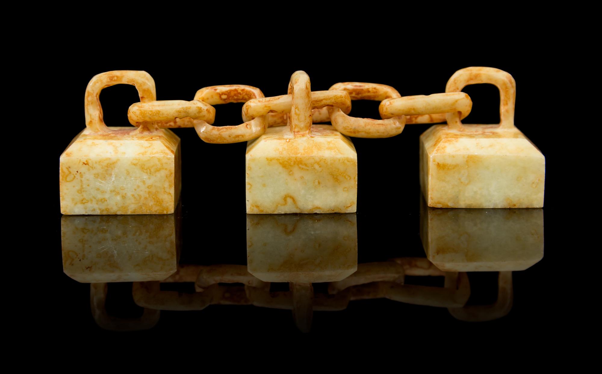 A Group of Three Celadon and Russet Jade Seals Length overall 4 inches.