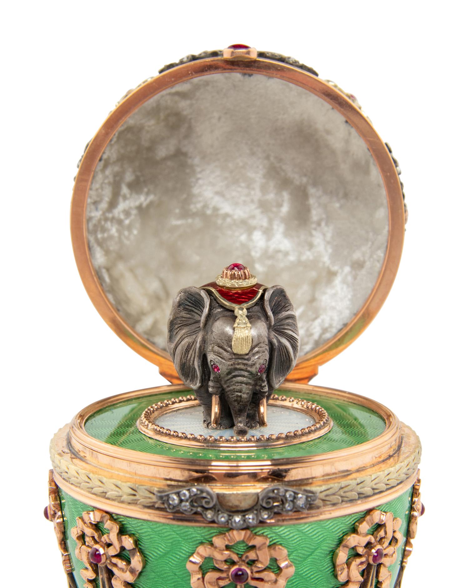 A Gold, Guilloché Enamel and Gemstone-Mounted Surprise Egg