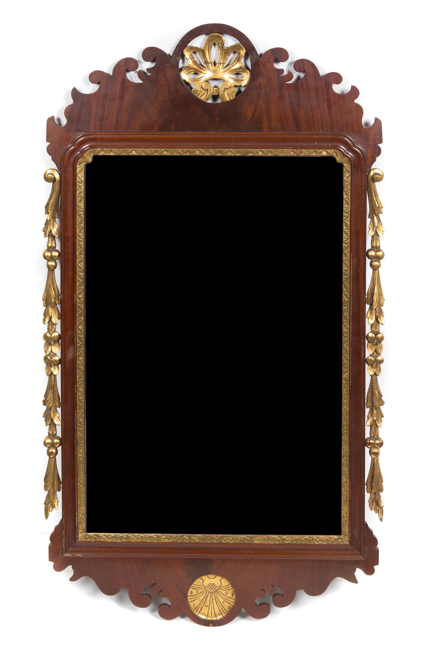 A Chippendale Style Mahogany and Parcel Gilt Mirror. Height 45 x width 26 1/2 inches.