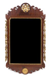 A Chippendale Style Mahogany and Parcel Gilt Mirror. Height 45 x width 26 1/2 inches.