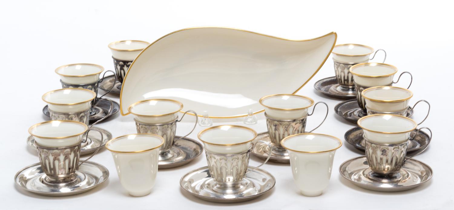 A Set of Twelve Silver Demitasse Cups and Saucers, , each cup with pierced decoration and Lenox porcelain liner, the saucers engraved w