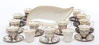 A Set of Twelve Silver Demitasse Cups and Saucers, , each cup with pierced decoration and Lenox porcelain liner, the saucers engraved w