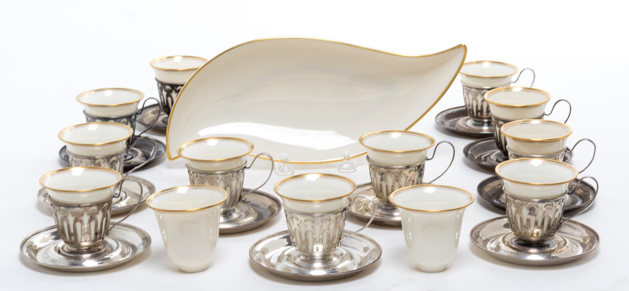 A Set of Twelve Silver Demitasse Cups and Saucers, , each cup with pierced decoration and Lenox porcelain liner, the saucers engraved w