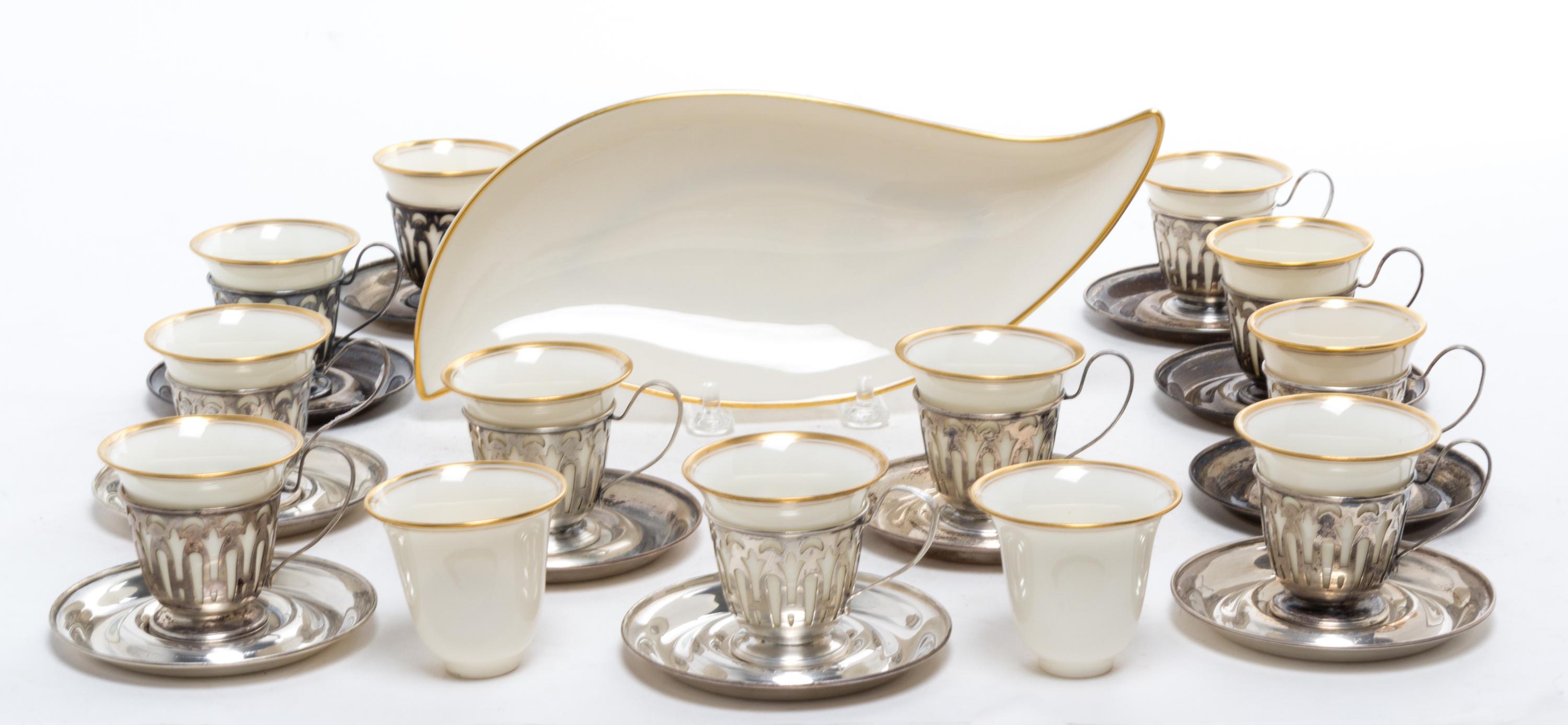 A Set of Twelve Silver Demitasse Cups and Saucers, , each cup with pierced decoration and Lenox porcelain liner, the saucers engraved w