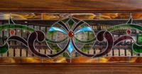 An American Mahogany and Leaded Glass Mounted Orchestrion with an Upholstered Bench
