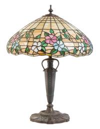 An American Leaded Glass and Bronze Lamp, THE MOSAIC SHADE COMPANY, CHICAGO, the shade having a floral pattern, raised on an vasiform s