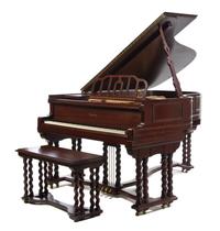 A Wurlitzer Jacobean Style Grand Piano, Height 39 1/2 x width 56 1/4 x depth 74 inches.