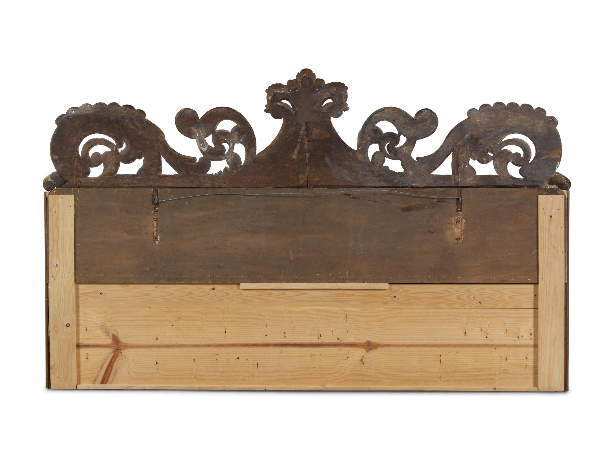 A Continental Carved and Parcel Gilt Wood Upholstered Headboard