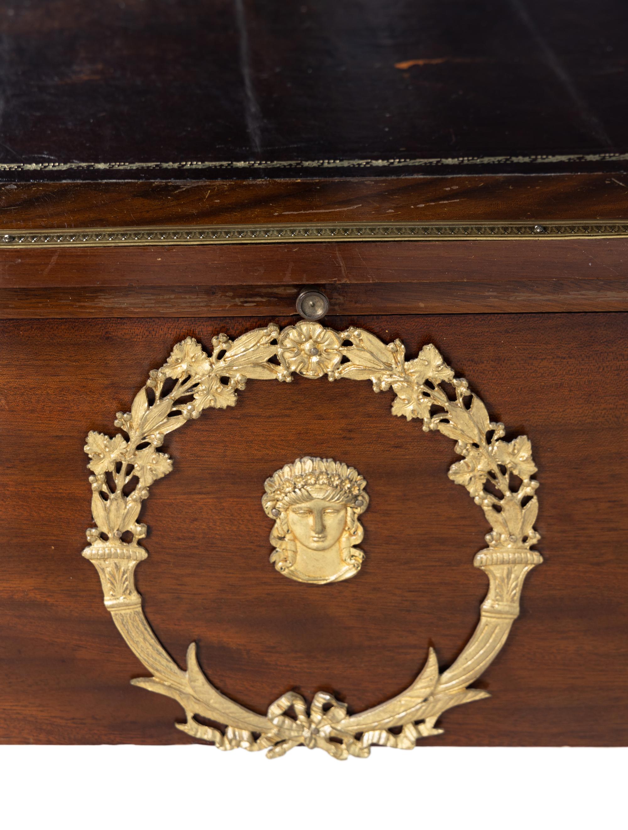 An Empire Style Gilt Metal Mounted Mahogany Bureau Plat and an Associated Armchair
