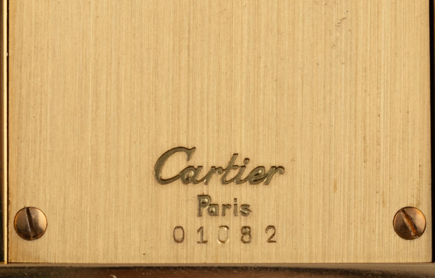 A Cartier Engraved Brass and Onyx Travel Clock