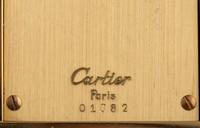 A Cartier Engraved Brass and Onyx Travel Clock