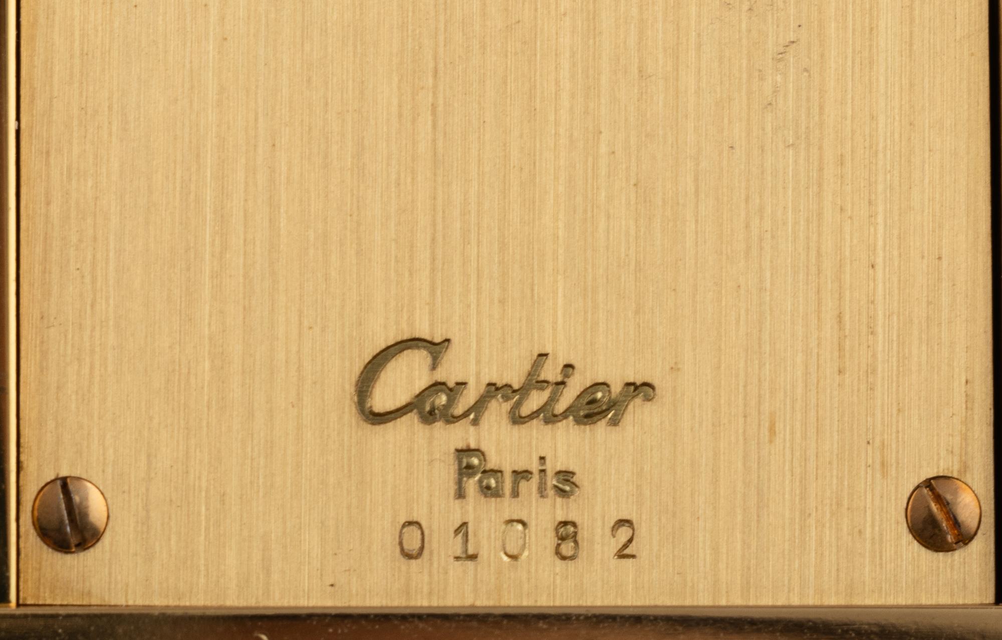 A Cartier Engraved Brass and Onyx Travel Clock