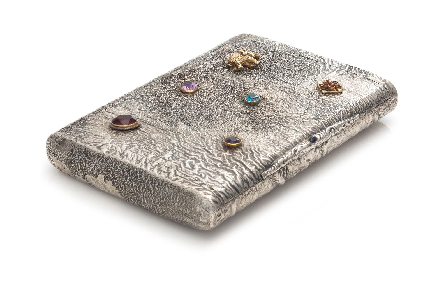 A Russian Silver Samodorok Cigarette Case, Maker's Mark A.D.A.M.B, Moscow, Early 20th Century, the lid with applied paste jewels and a