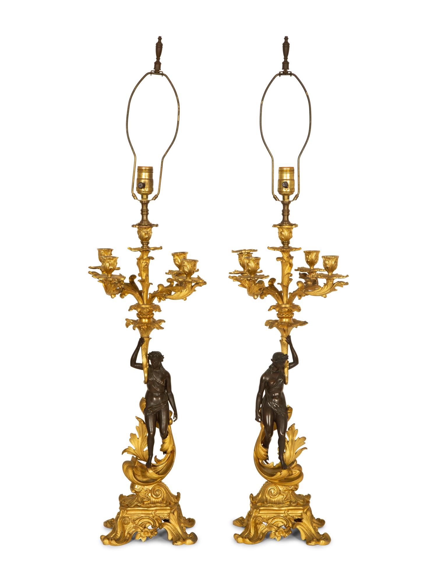 A Pair of Patinated and Gilt Bronze Figural Five-Light Candelabra Mounted as Lamps