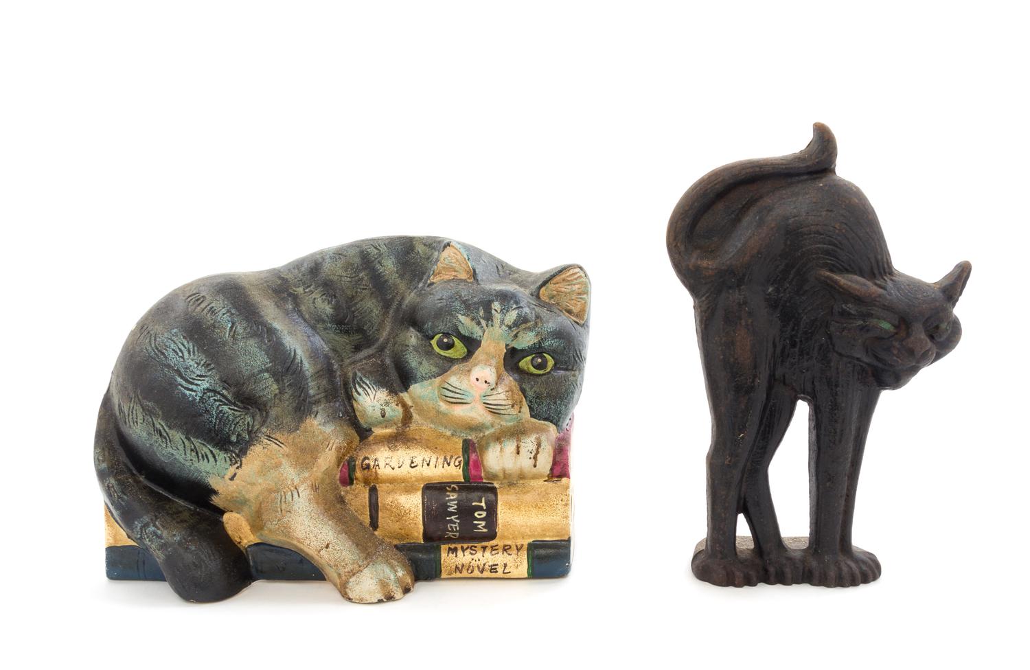 Two Cast Iron Doorstops Height of tallest 10 inches.