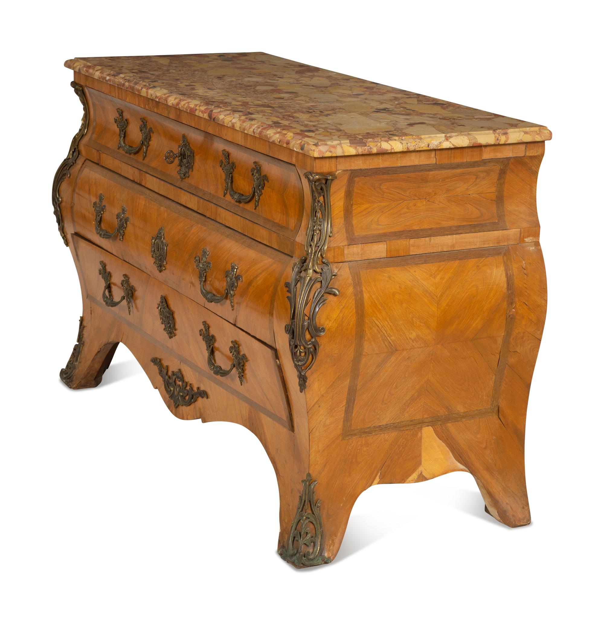 A Régence Style Gilt Metal Mounted Breche d'Alep Marble Top Commode