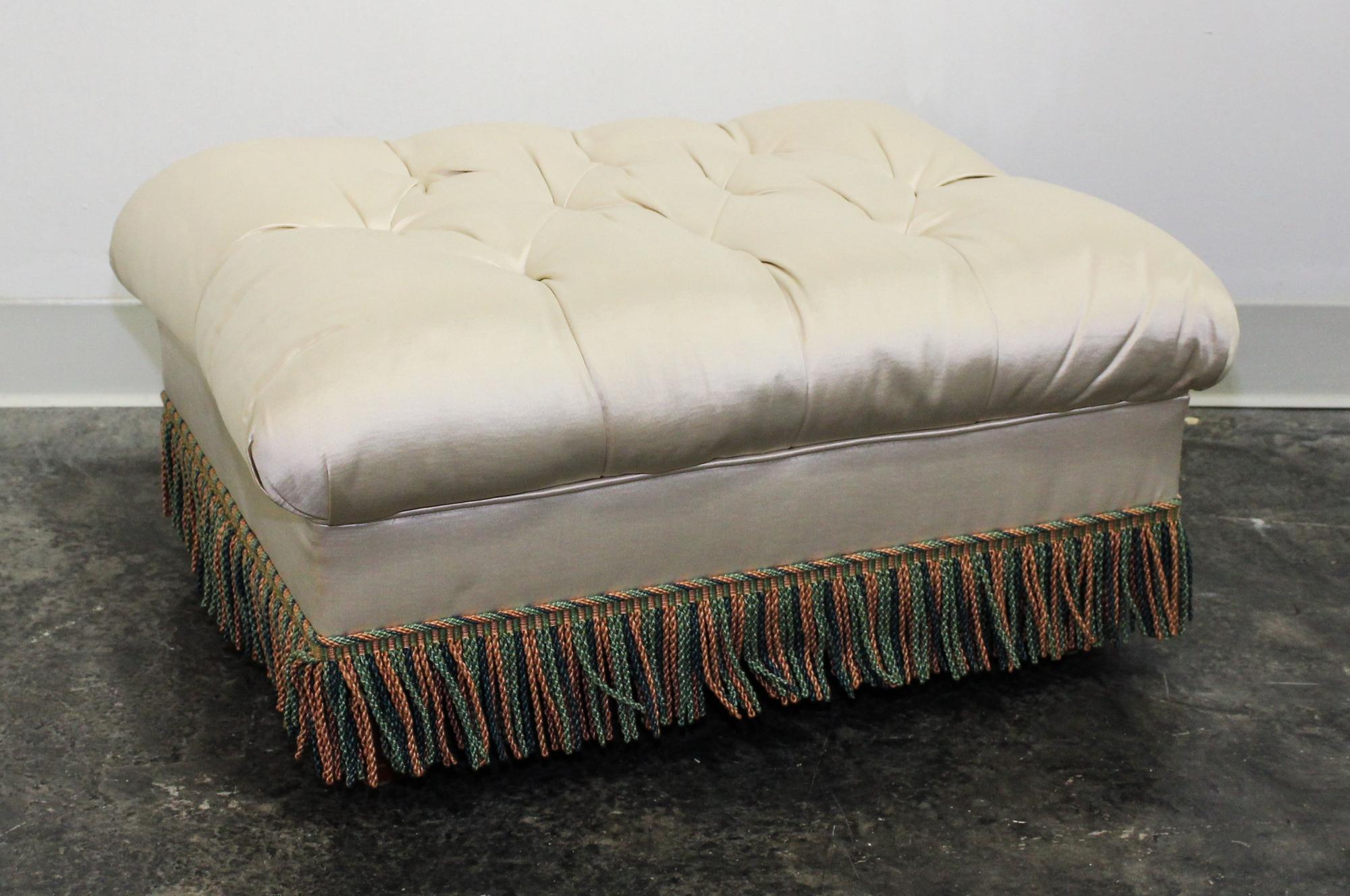 An Upholstered Ottoman Height 12 1/2 x width 25 1/2 x depth 19 inches (overall).