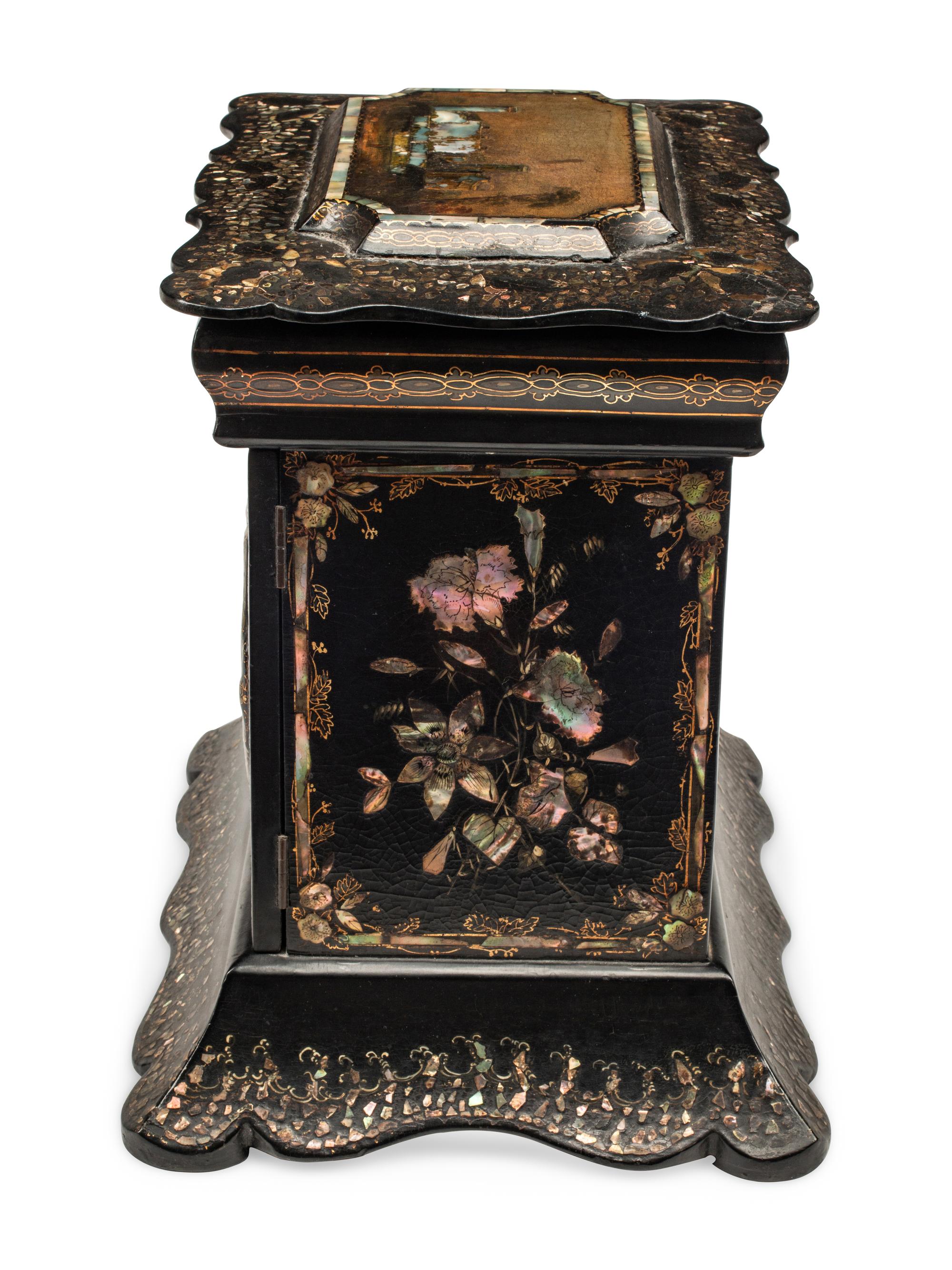 An English Mother-of-Pearl Inlaid Ebonized Cabinet