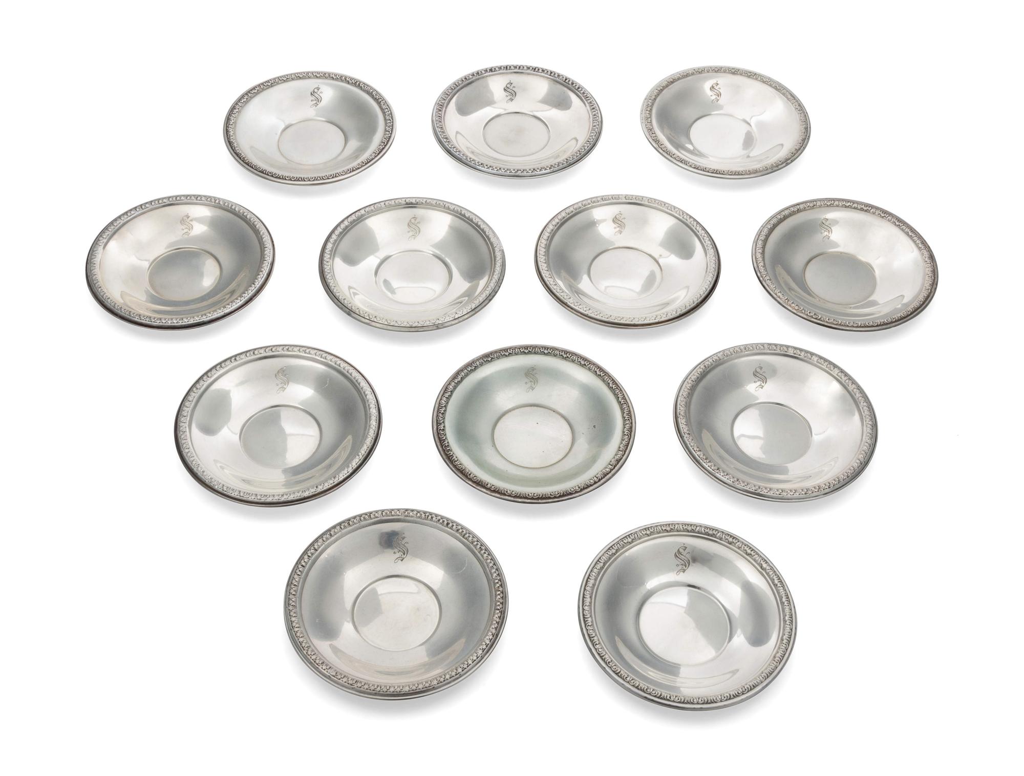 A Set of 12 Silver Butter Pats