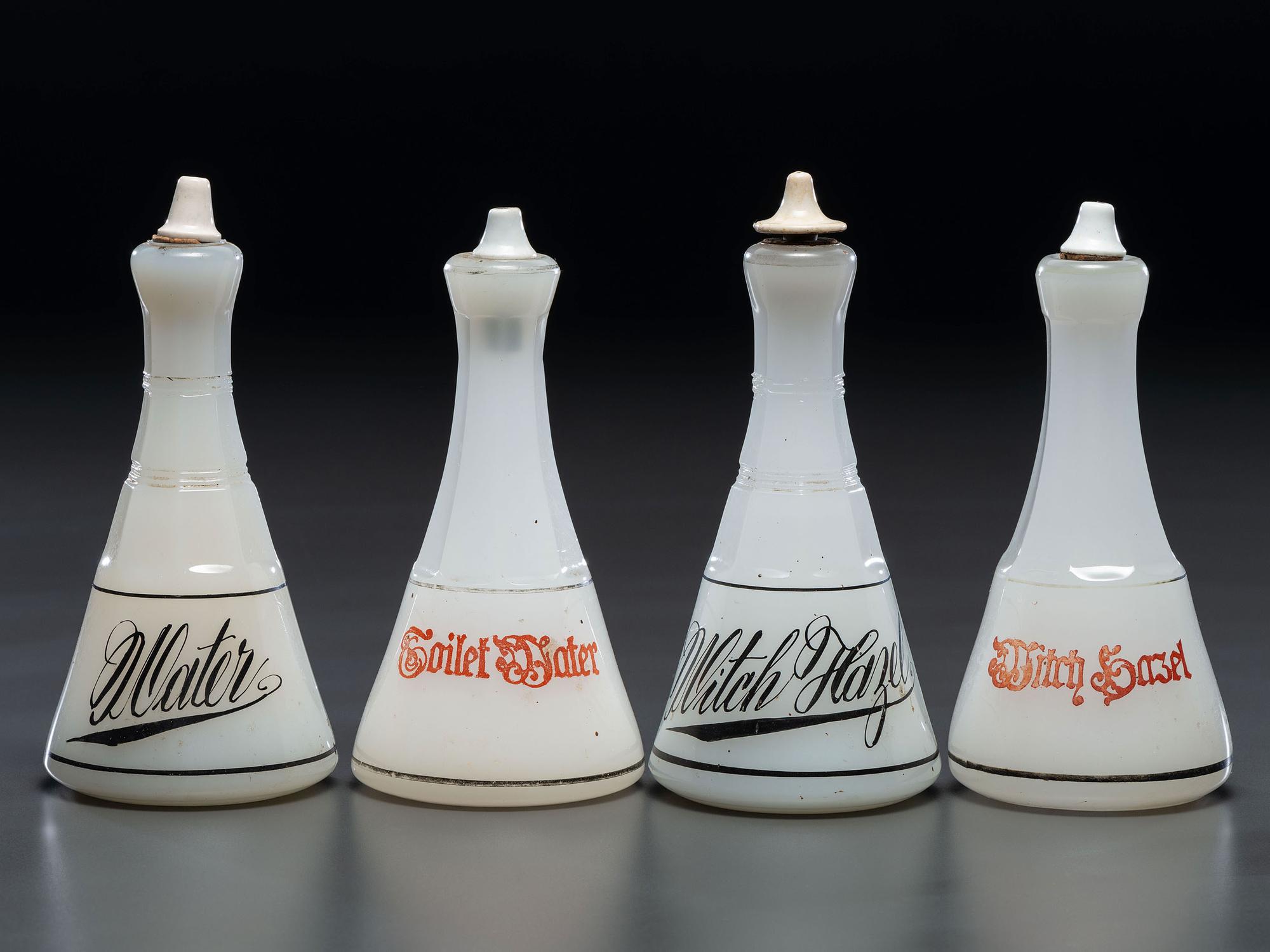 Four Milk Glass Barber Bottles with Ceramic Stoppers