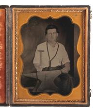 [EARLY PHOTOGRAPHY]. Quarter plate tintype of a blacksmith posed with a hammer and anvil.