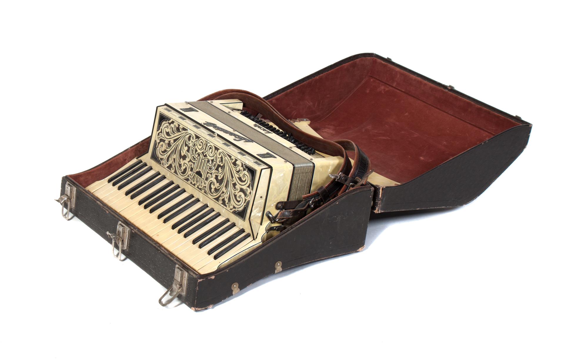 A Scandalli Loreto Accordion Height of case 17 3/4 x width 22 1/4 x depth 8 1/2 inches.