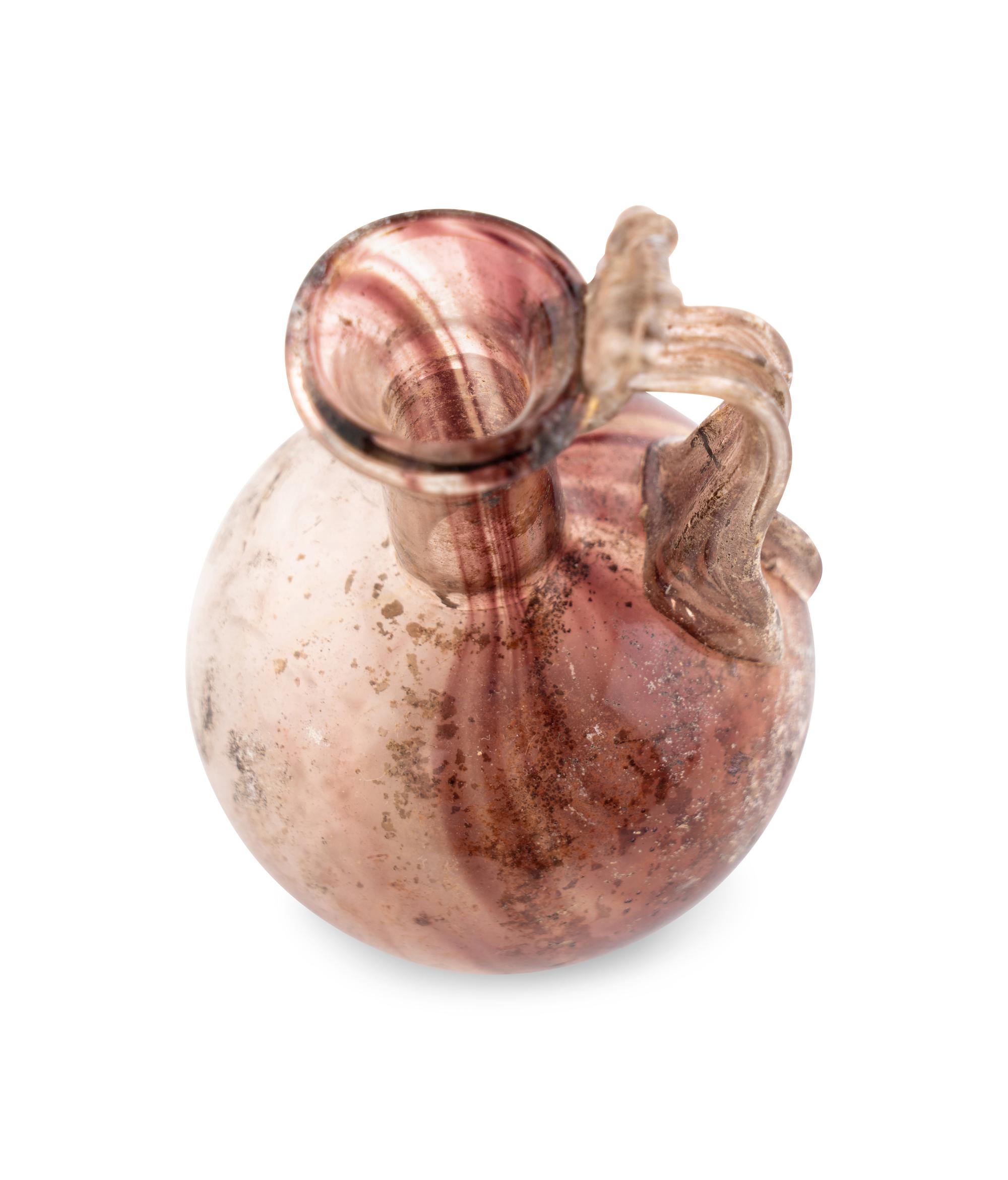 A Roman Glass Jug with Fluted Handle and Thumb Rest